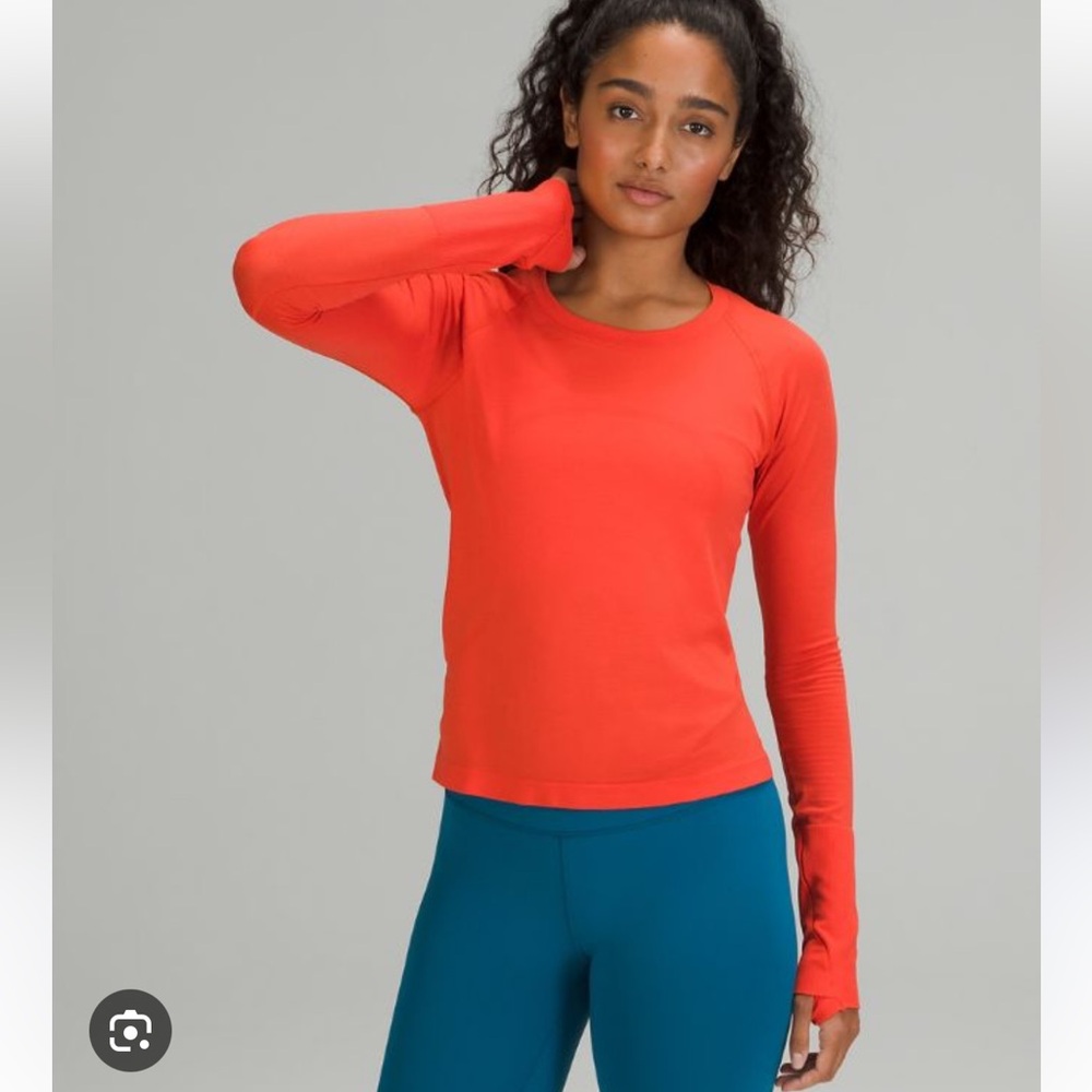Lulu swiftly tech long sleeve in race length. Solar orange color